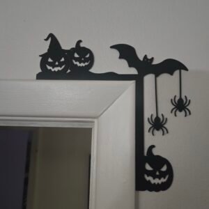 Halloween door art with spiders, bat, and pumpkins